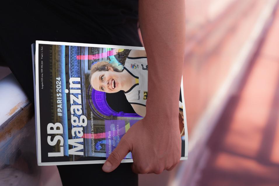 Hand h&auml;lt ein geschlossenes Magazin mit der Aufschrift &bdquo;LSB Magazin&ldquo; und einem lachenden Sportler auf dem Cover.